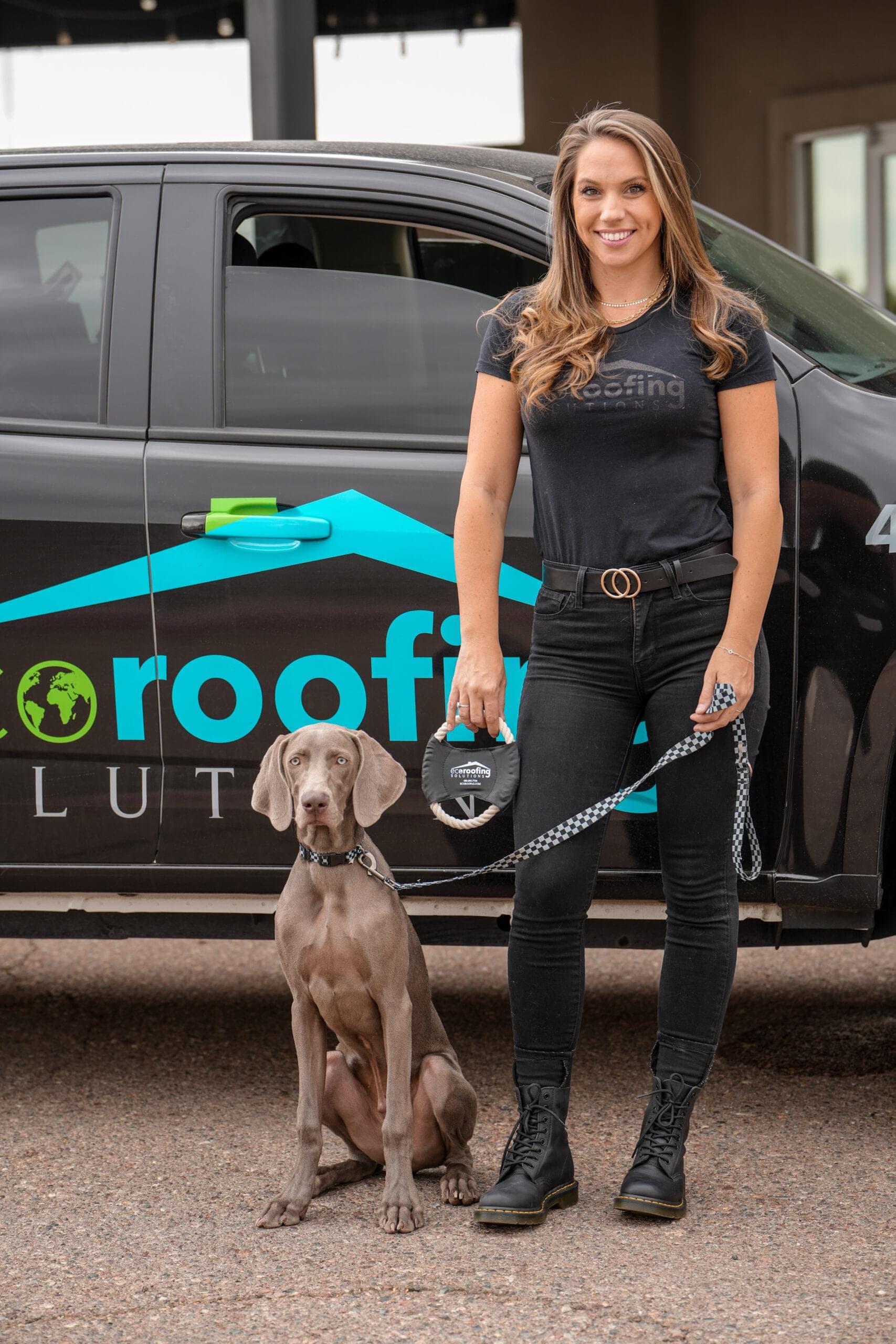 Eco Roofing Solutions team member with a Weimaraner on a leash in front of a branded company truck