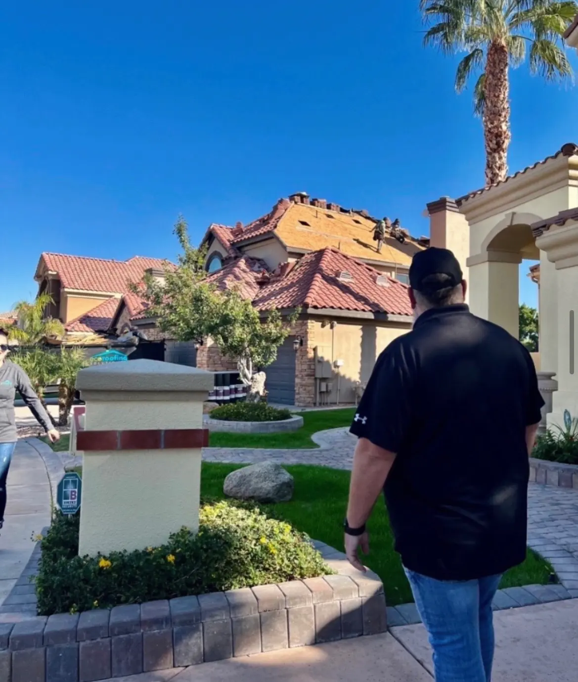 Long run of terracotta barrel tile on an Arizona home with mortar-set ridge caps and vent boots