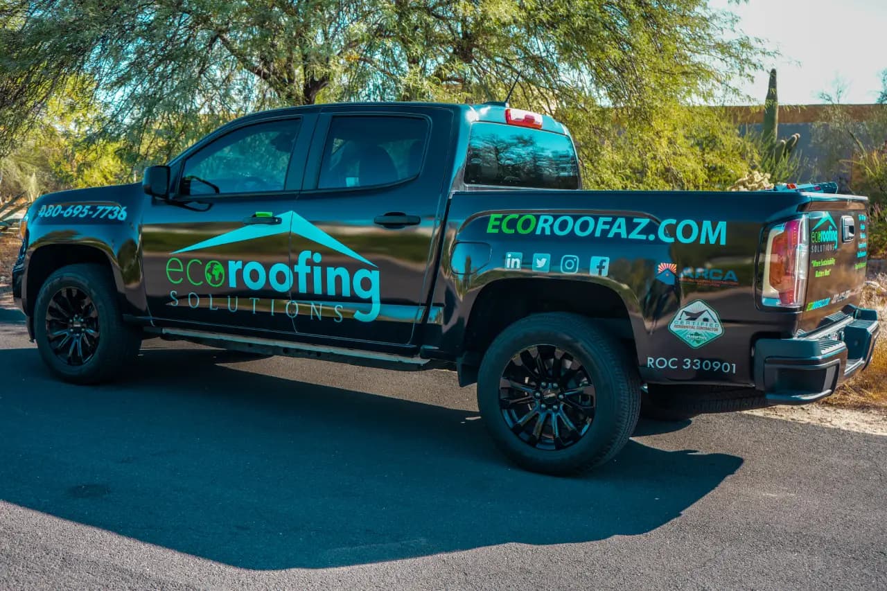 Eco Roofing Solutions branded pickup truck with the company phone number and ROC license on the tailgate